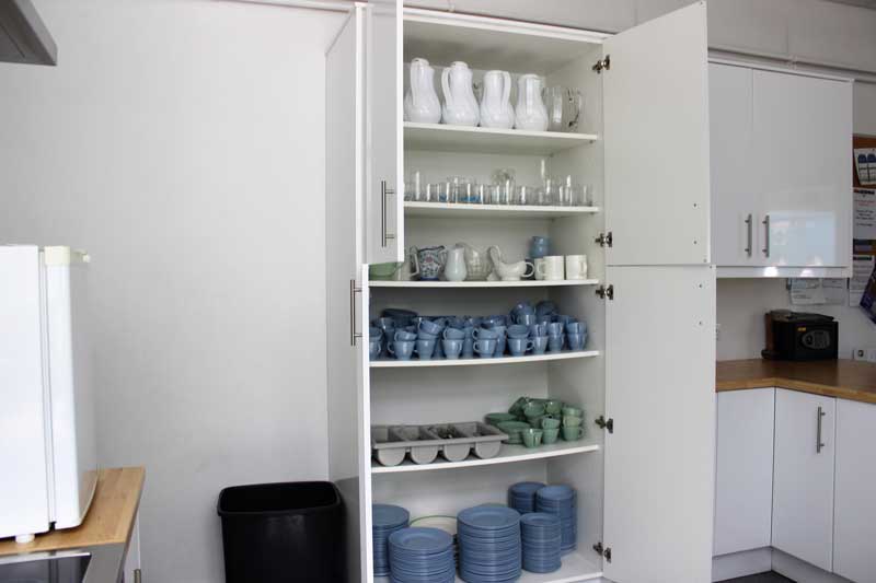 Kitchen crockery & cutlery in cupboard