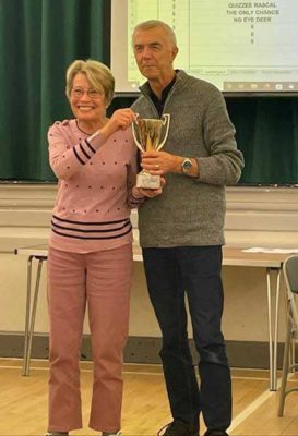 Gill Poole, captain of the winning quiz team, receiving trophy from Brian Butcher