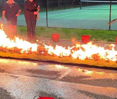 The firewalk in flames before it settled down to red hot coals